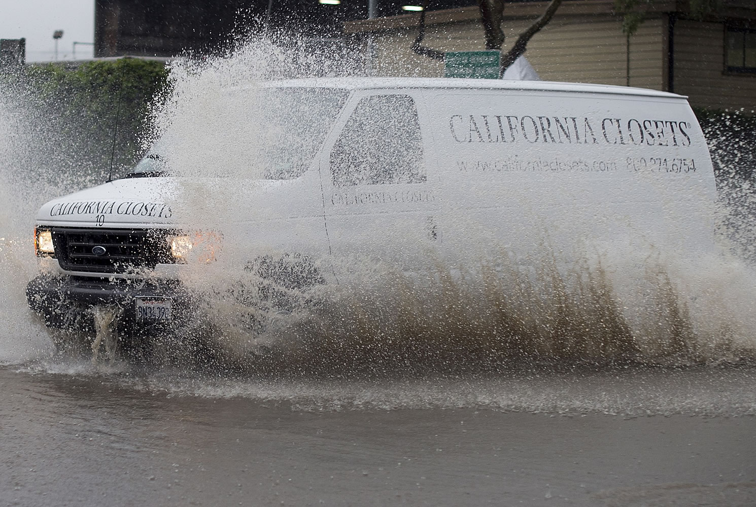 A van navigates a flooded roadway in Berkeley, Calif., on Thursday, Dec. 11, 2014. A powerful storm churned through Northern California Thursday, knocking out power to tens of thousands and delaying commuters while soaking the region with much-needed rain.