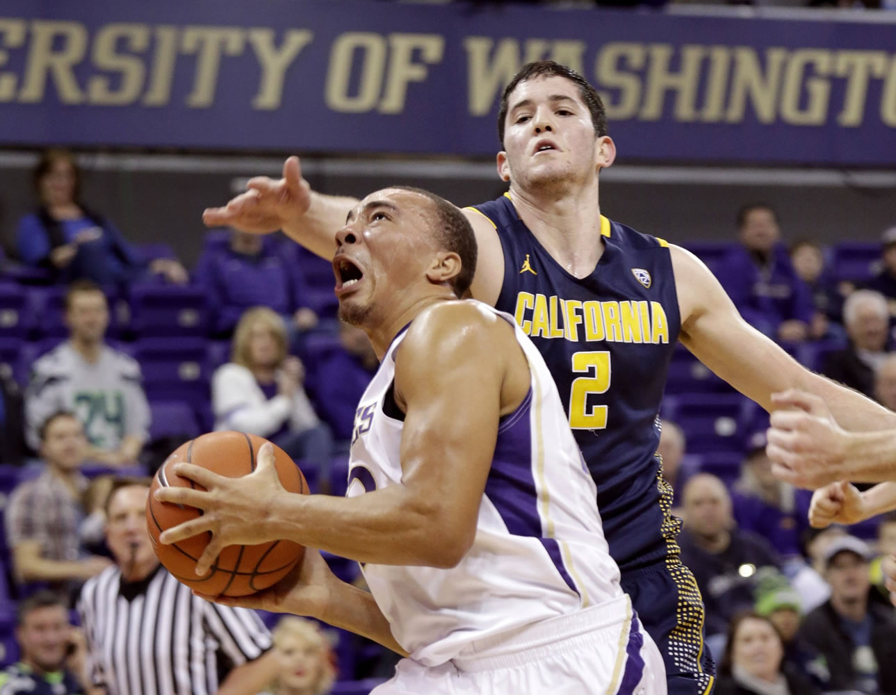 Washington's Andrew Andrews drives to the basket past California's Sam Singer in the first half on Sunday, Feb. 1, 2015, in Seattle.
