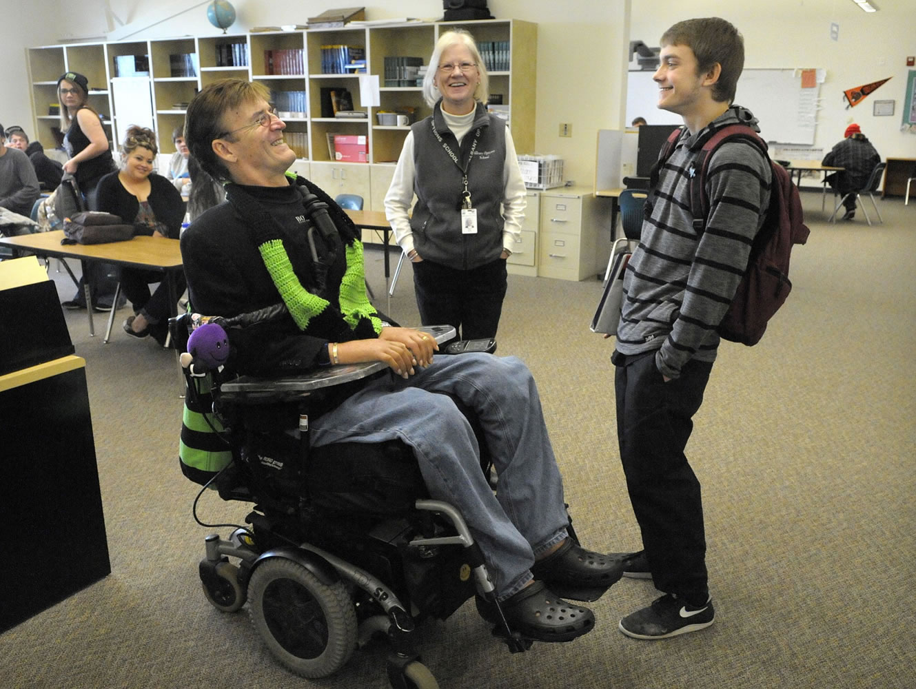 Motivational speaker Ron Heagy Jr. of Millersburg, Ore., left, talks with Warren Scott Brown, 17, and teacher Deanna Kozak after speaking to students at Albany Options School in Albany, Ore.