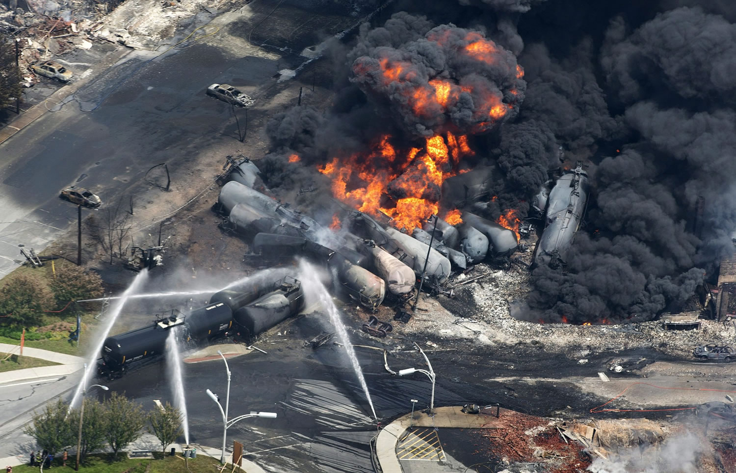 Black smoke billows from burning tanker cars on July 6, 2013, in Lac-Megantic, Quebec.