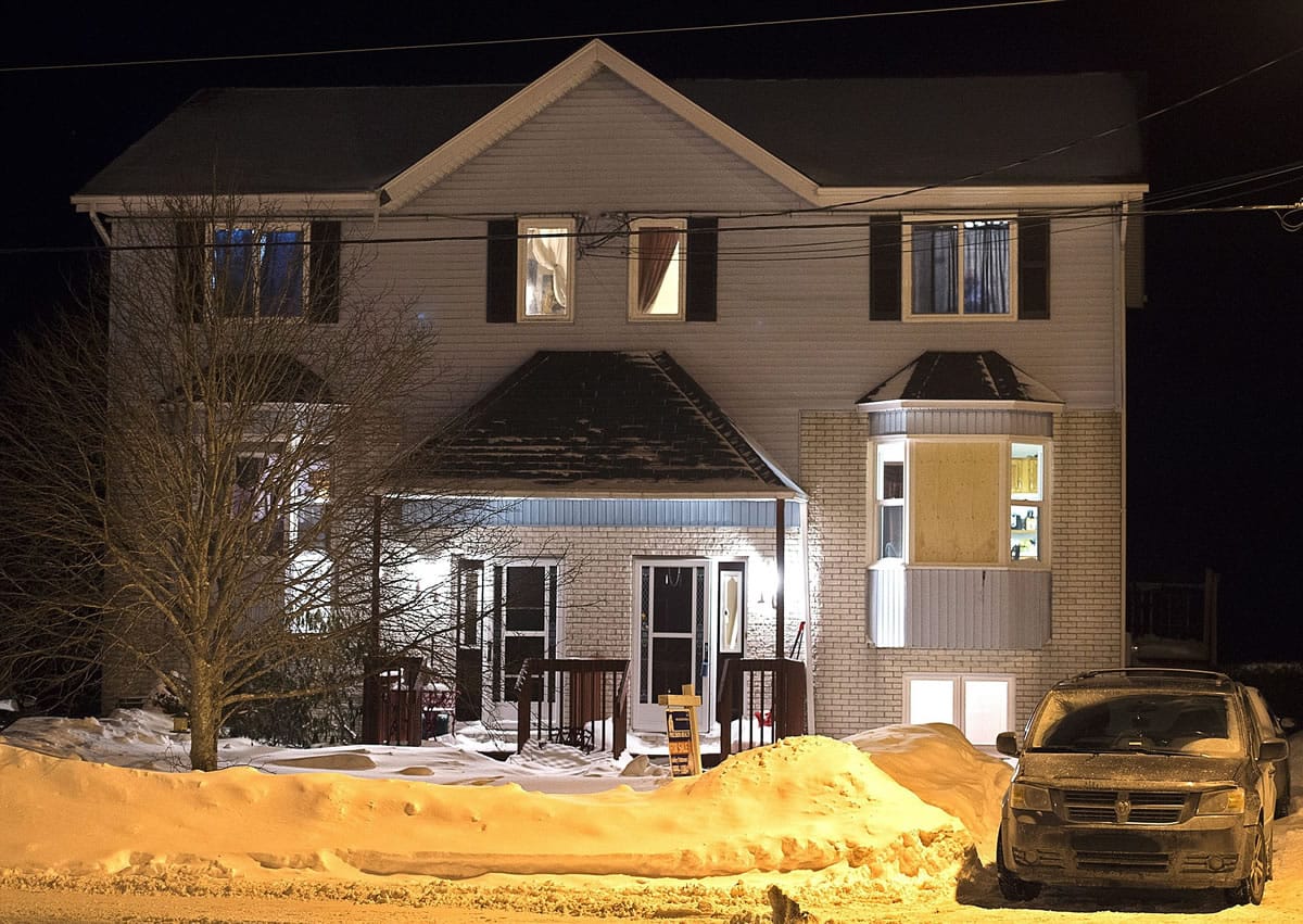 A car is parked outside a home on Tiger Maple Drive in Timberlea, Nova Scotia, a Halifax suburb, where police found a deceased person Friday, Feb. 13, 2015. A senior police official said Friday police foiled a plot by suspects who were planning on going to a mall and killing as many people as they could before killing themselves on Valentine's Day in Halifax. The official told The Associated Press the suspects were on a chat stream and were apparently obsessed with killing and death and had many photos of mass killings.