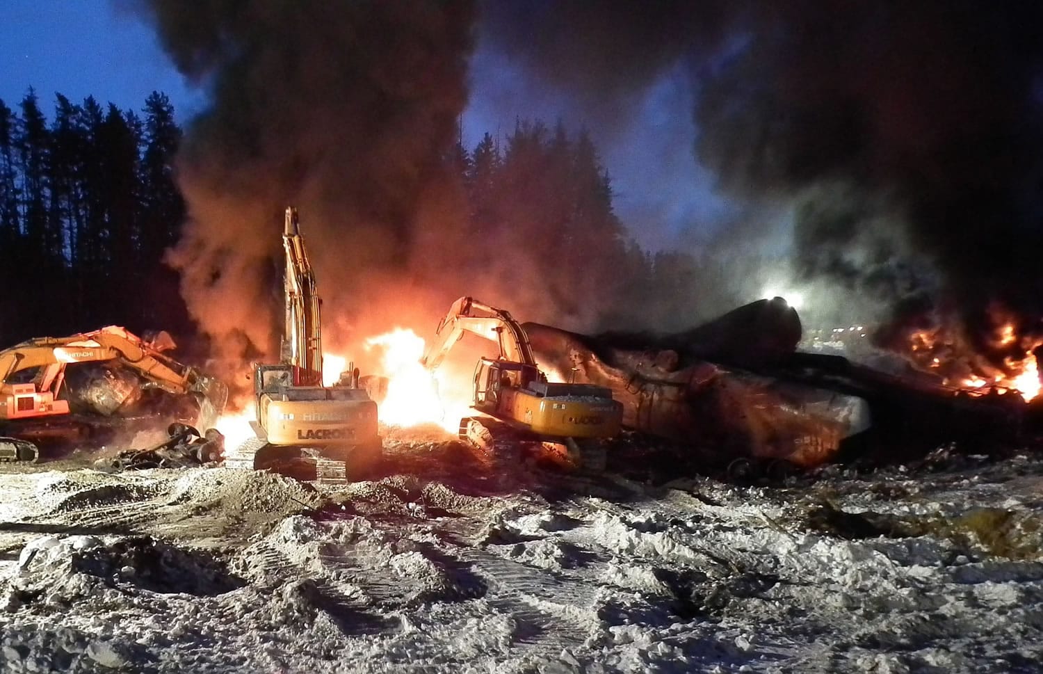 Transportation Safety Board of Canada files
Workers fight a fire Feb. 16 after a crude oil train derailment south of south of Timmins, Ontario. The train derailment this month suggests new safety requirements for tank cars carrying flammable liquids are inadequate, Canada's transportation safety board announced Monday.