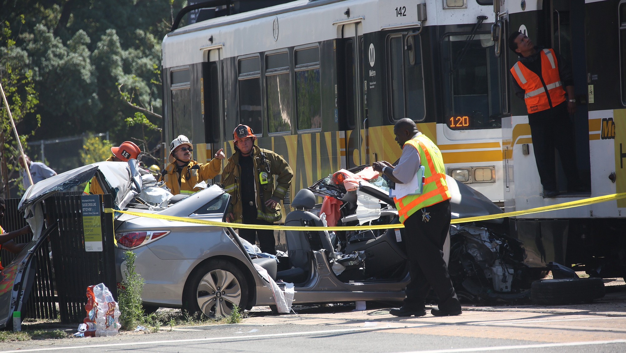 Emergency personnel work at the site of a collision between and Expo Line commuter train and a vehicle near downtown Los Angeles on Saturday, March 28, 2015.