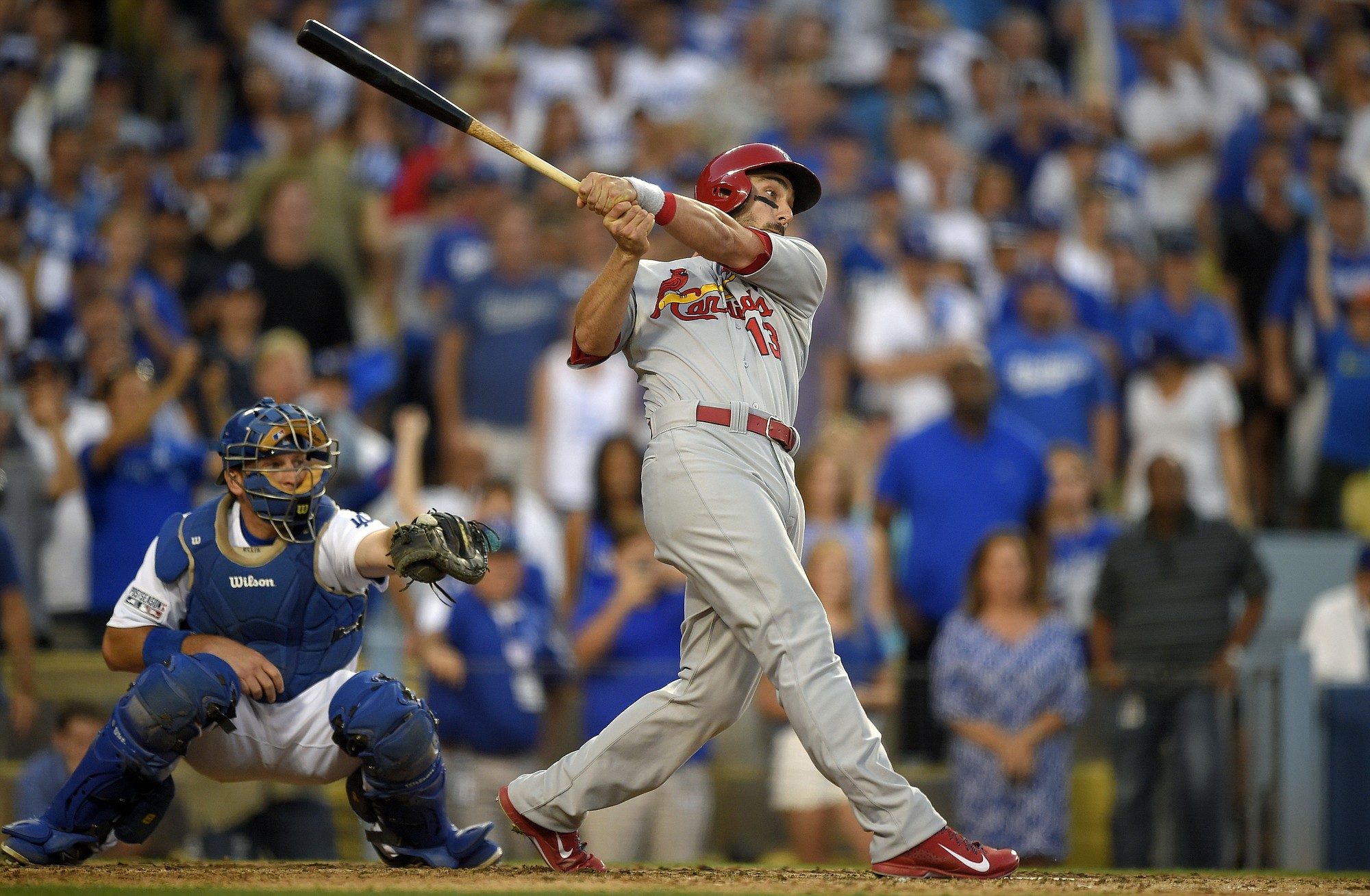 St. Louis Cardinals' Matt Carpenter, right, hits a three-RBI double as Los Angeles Dodgers catcher A.J. Ellis looks on in the seventh inning of Game 1 in the NL Division Series in Los Angeles, Friday, Oct. 3, 2014. (AP Photo/Mark J.