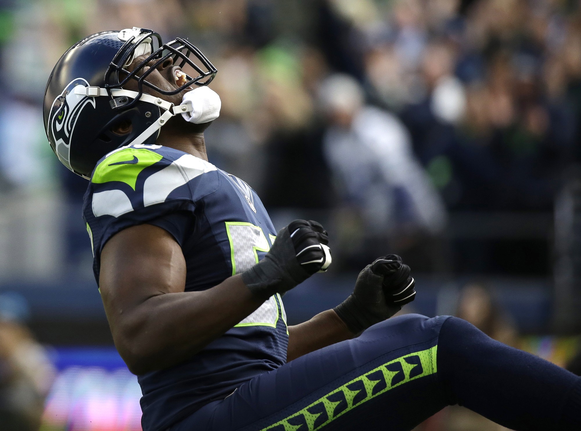 Seattle Seahawks defensive end Cliff Avril reacts after he sacked Arizona Cardinals quarterback Drew Stanton in the first half of an NFL football game, Sunday, Nov. 23, 2014, in Seattle.