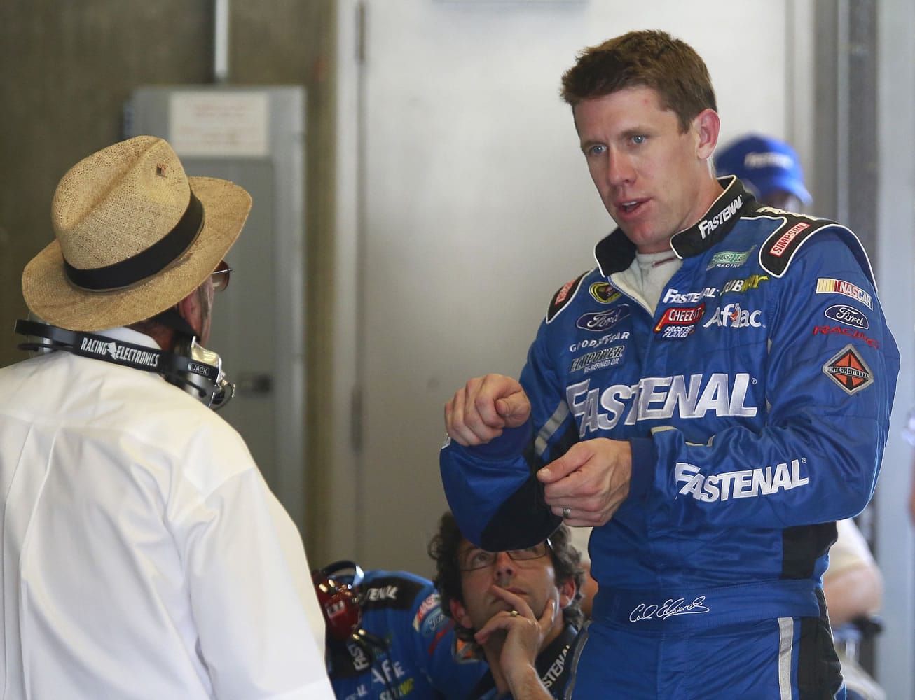 Driver Carl Edwards talks with owner Jack Roush during practice for the Brickyard 400 Sprint Cup series auto race at the Indianapolis Motor Speedway in Indianapolis, Friday, July 25, 2014.