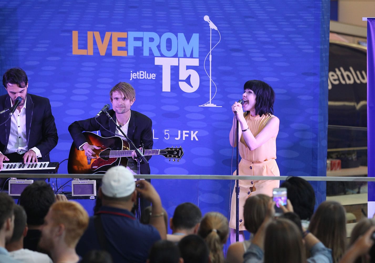 Singer Carly Rae Jepsen, right, performs songs Thursday from her new album, &quot;Emotion,&quot; live from JetBlue's Terminal 5 in New York.