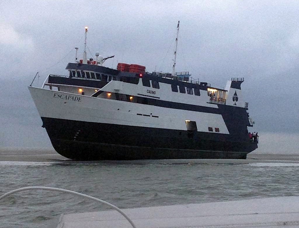 In this photo provided by the U.S. Coast Guard, the casino boat Escapade, with 123 people aboard, is grounded Wednesday off the coast of Tybee Island, Ga. No injuries or medical issues had been reported among the 96 passengers and 27 crew members aboard the boat according to Coast Guard Petty Officer 3rd Class Anthony L.