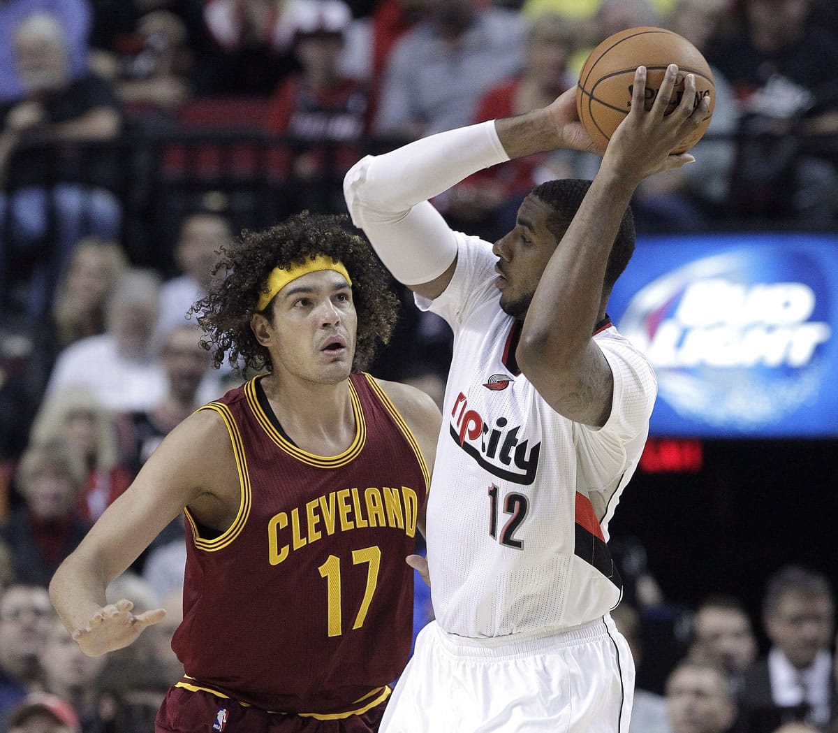 Portland Trail Blazers forward LaMarcus Aldridge, right, looks to pass as Cleveland Cavaliers center Anderson Varejao, from Brazil, defends during the first half of an NBA basketball game in Portland, Ore., Tuesday, Nov.