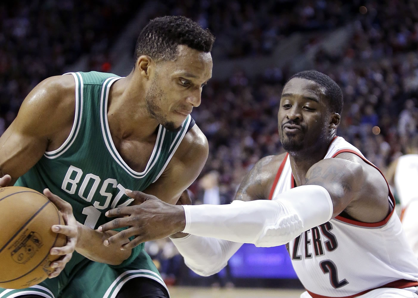 Boston Celtics guard Evan Turner, left, looks to maneuver against Portland Trail Blazers guard Wesley Matthews during the second half Thursday, Jan. 22, 2015. Turner scored 10 points, including the game-winning 3-pointer, in the Celtics' 90-89 victory.