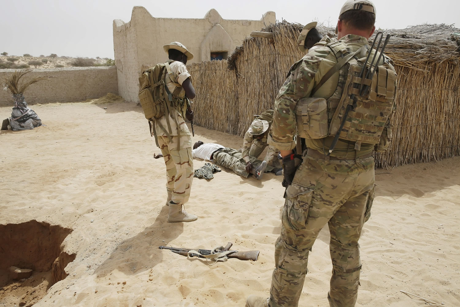 Chadian troops participate along with Nigerian special forces watched by a US special forces soldier, at right, in an hostage rescue exercise at the end of the Flintlock exercise in Mao, Chad, on Saturday. The U.S.