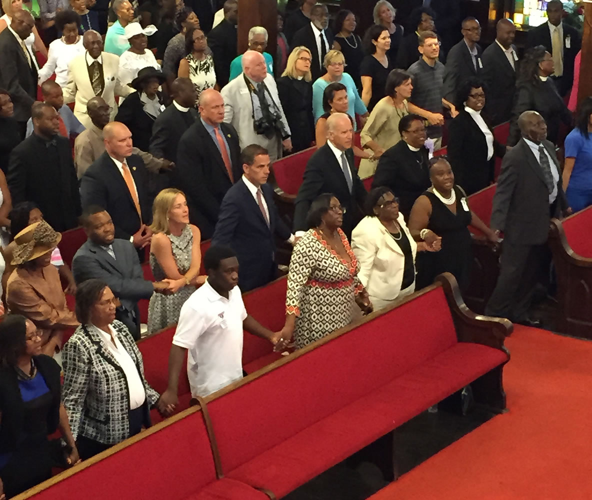 Vice President Joe Biden, center, with son and daughter-in-law Hunter and Kathleen Biden, to his right, sing &quot;We Shall Overcome&quot; while joining hands with Emanuel AME Church members Sunday in Charleston, S.C.