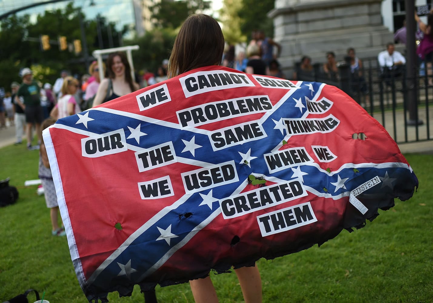 Mariangeles Borghini holds a burned Confederate flag during a rally to take down the Confederate flag at the South Carolina Statehouse on Saturday in Columbia, S.C. Rep.