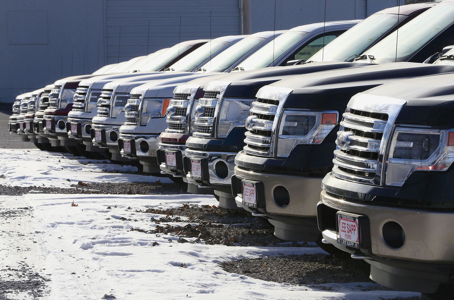 Ford F-150 pickup trucks are lined up Jan. 13 at the Lee Sapp Ford dealership in Ashland, Neb. With cheaper gasoline in the tank, some car dealers find they have too many smaller fuel-efficient cars, when trucks and sports cars might sell better.