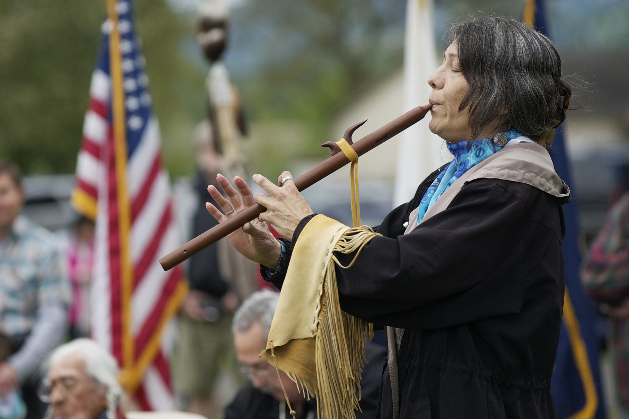 Katherine Quartz from the Walker River Paiute tribe plays the flute song &quot;Waterflow&quot; to honor the infant son of Little Bear during the 16th annual Nez Perce Chief Redheart Memorial Ceremony at the Fort Vancouver National Historic Reserve.