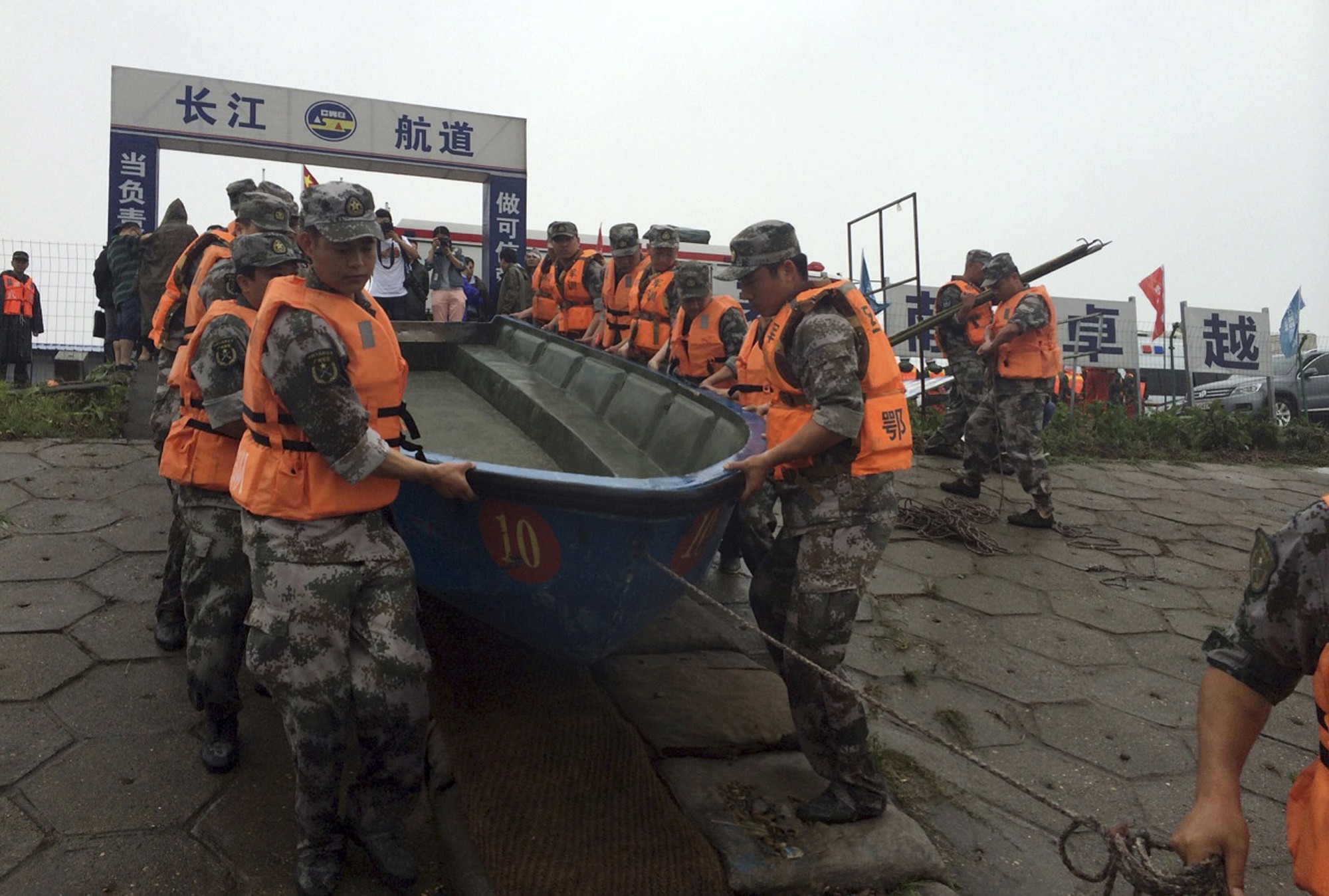Rescue workers prepare to head out on boats on the Yangtze River to search for missing passengers after a ship capsized in central China's Hubei province Tuesday.  The passenger ship carrying more than 450 people sank overnight in the Yangtze River during a storm in southern China, the official Xinhua News Agency reported Tuesday.