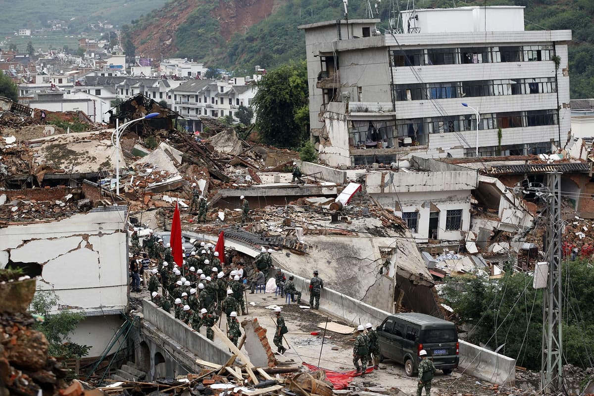 Associated Press
Rescuers search for survivors Monday among the remains of collapsed buildings in the epicenter of an earthquake that struck the town of Longtou in southwest China.