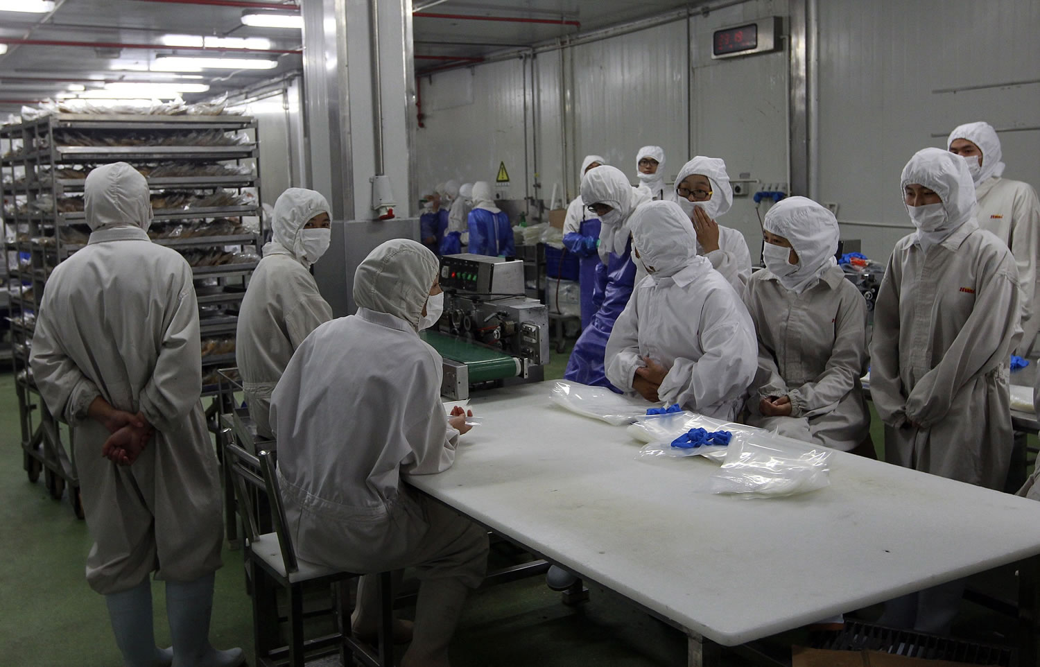 Workers gather while they have nothing to do at the workshop of Shanghai Husi Food Co., a meat supplier for McDonaldu2019s and KFC owned by OSI Group, a privately-held company thatu2019s based in Aurora, Ill.