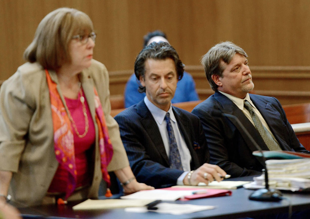 Dennis Nebus, right, of Boca Raton, sits in court with his lawyers May Cain and William Snihur, Jr., in a continuing legal battle with Heather Hironimus, the mother of his son, who has been fighting his efforts to have their son circumcised, in Delray Beach, Fla.