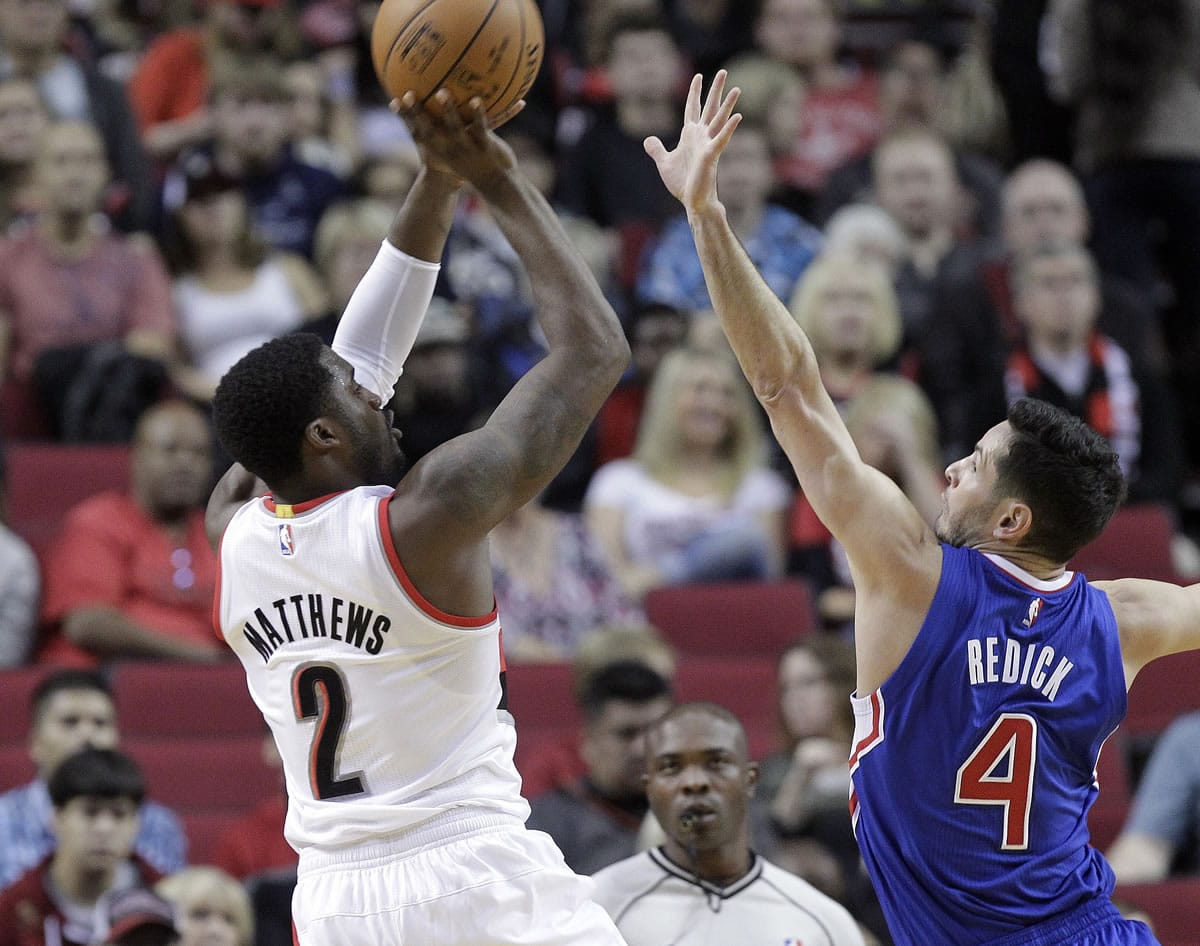 Portland Trail Blazers guard Wesley Matthews, left, shoots over Los Angeles Clippers guard J.J. Redick during the first half of Sunday's preseason game in Portland, Ore., Sunday, Oct.