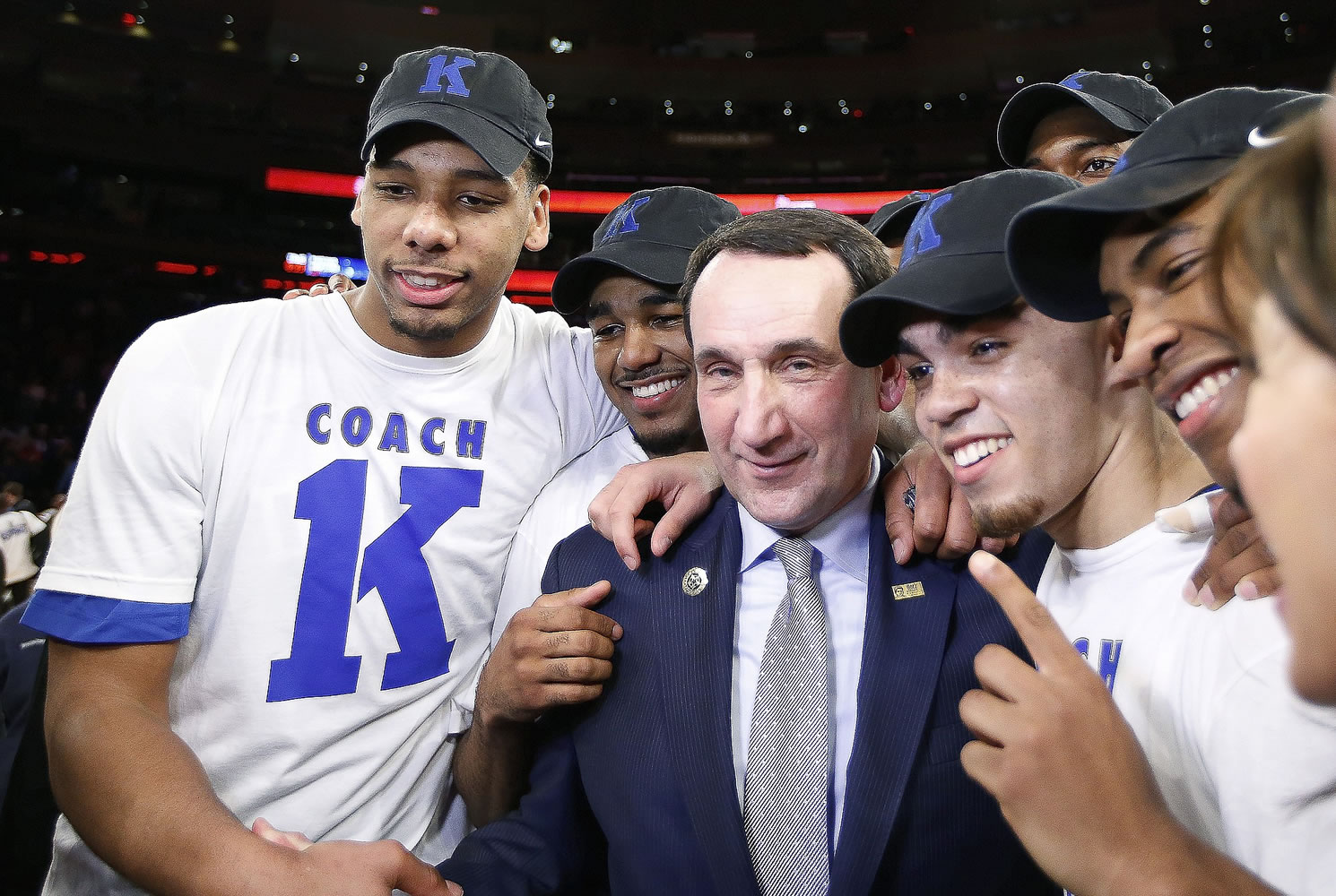 Duke head coach Mike Krzyzewski, center, celebrates with his players after his 1,000th career win in an NCAA college basketball game against St. John's at Madison Square Garden in New York, Sunday, Jan. 25, 2015. Krzyzewski became the first men's coach in Division I history with 1,000 wins.