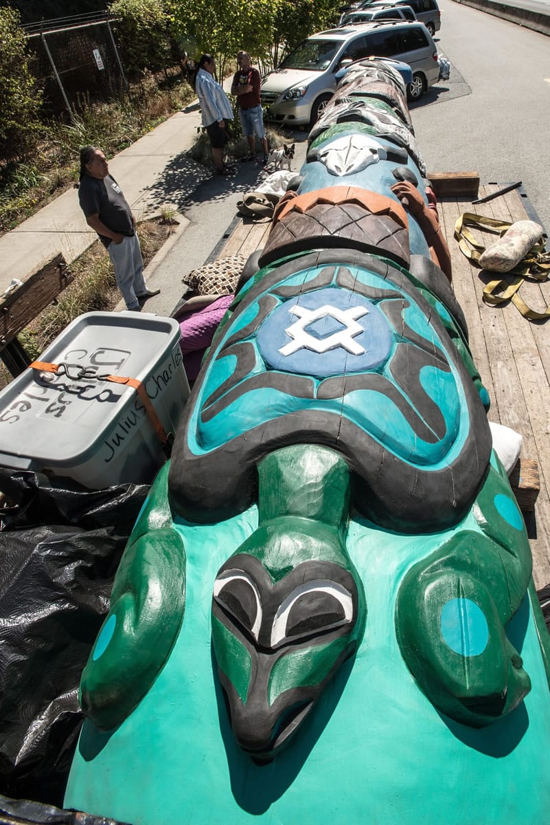 A truck carrying a totem pole carved by the Lummi Nation stops outside Vancouver, B.C., Friday, Aug. 21, the totem's first stop on a journey from Canada through the Pacific Northwest to Montana.