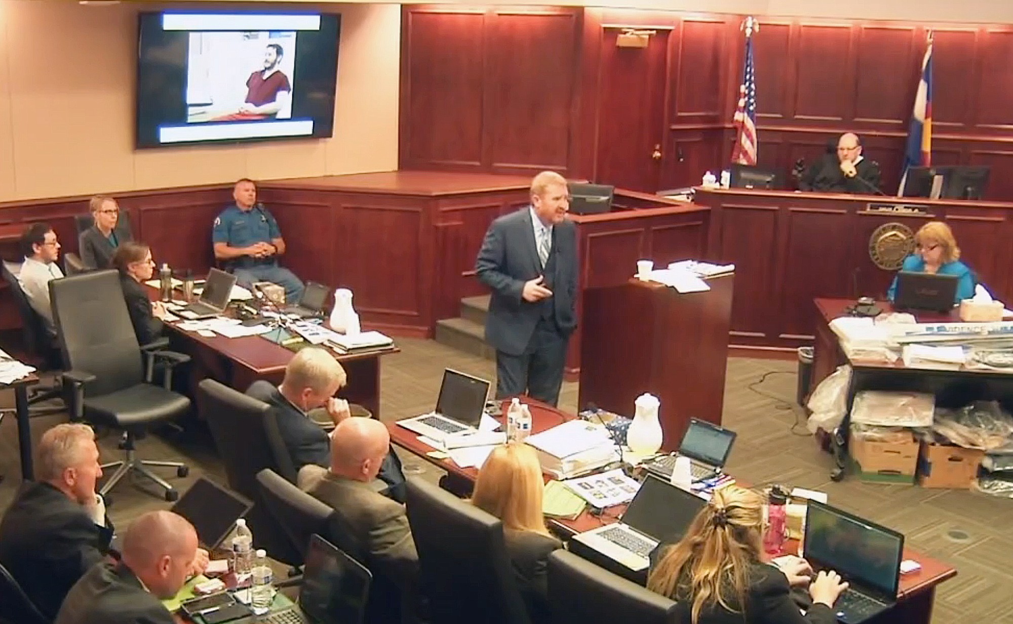 Accused Colorado theater shooter James Holmes, on the upper far left, listens to defense attorney Daniel King give closing arguments during his trial in Centennial, Colo., on Tuesday.