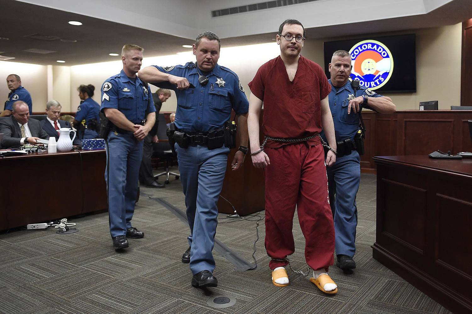 RJ SANGOSTI/The Denver Post via AP
James Holmes is led out of the courtroom Wednesday after being formally sentenced in Centennial, Colo. He was sentenced to life in prison without parole.