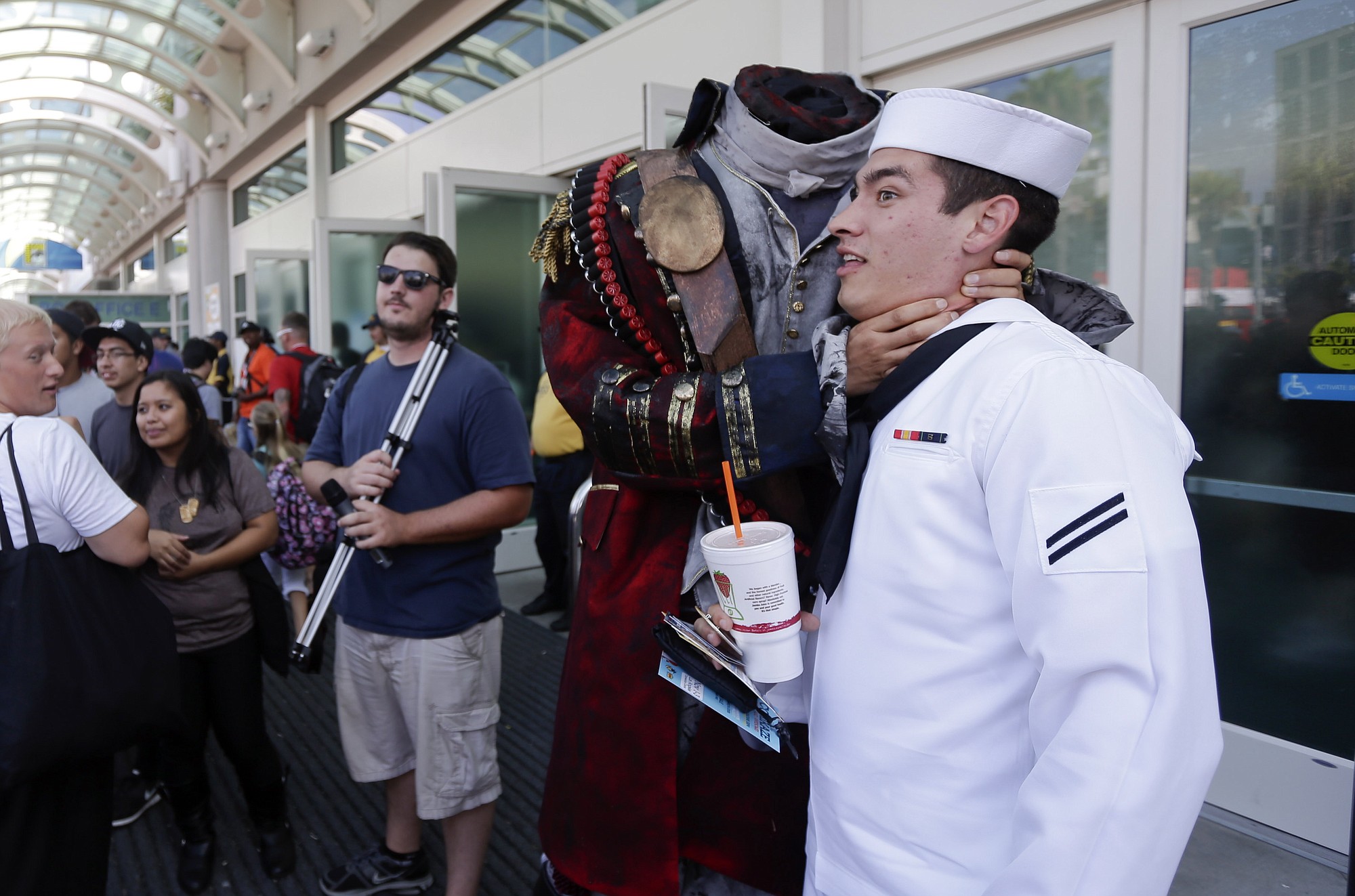 Navy Mineman Bradley Allred jokes as he has his picture taken with a headless character during Comic-Con 2013 in San Diego.