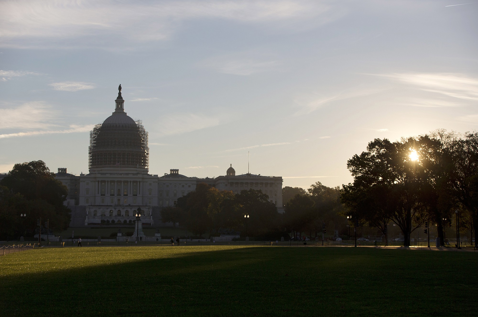 The sun rises behind the Capitol Building in Washington.