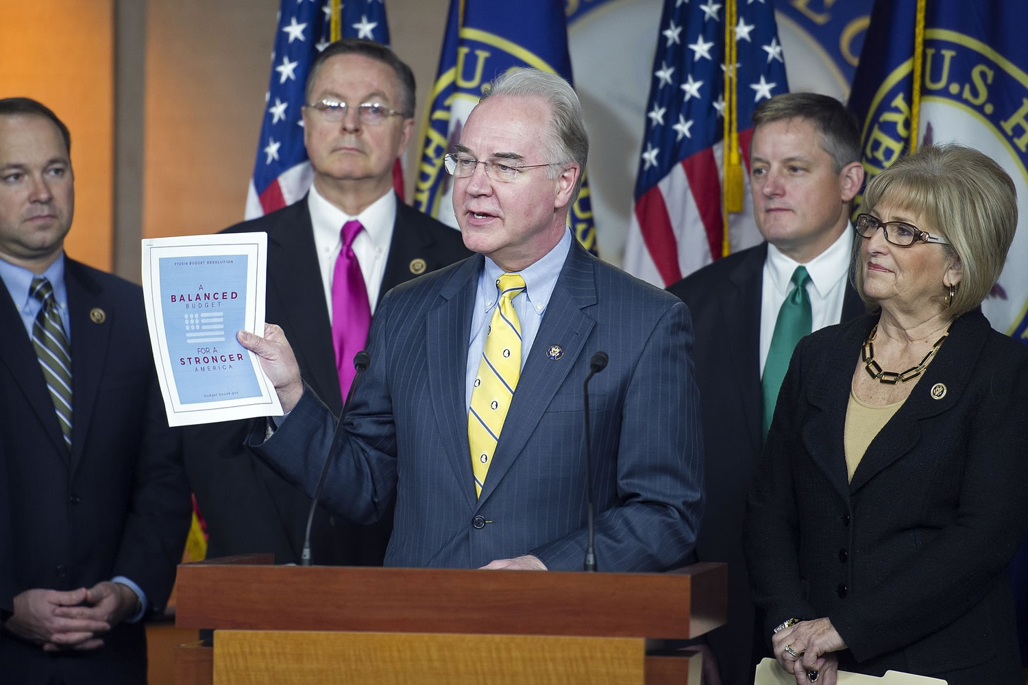 House Budget Committee Chairman Rep. Tom Price, R-Ga., center, holds-up a synopsis of  the House Republican budget proposal as he announces the plan on Capitol Hill in Washington on Tuesday.