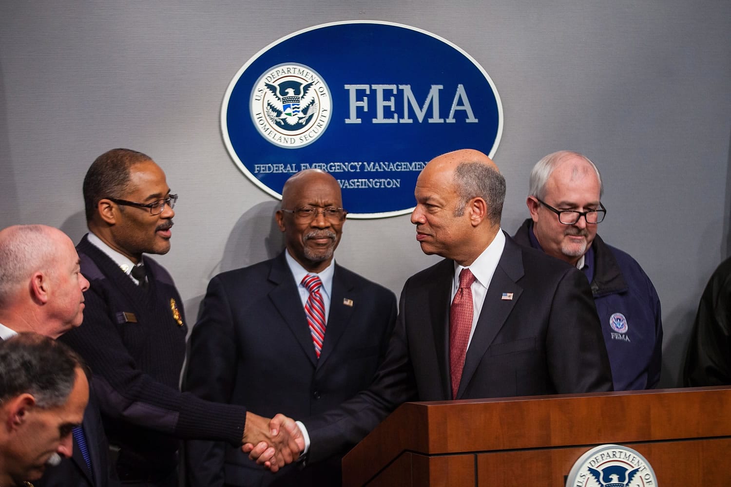 Homeland Security Secretary Jeh Johnson shakes hands with Interim D.C.