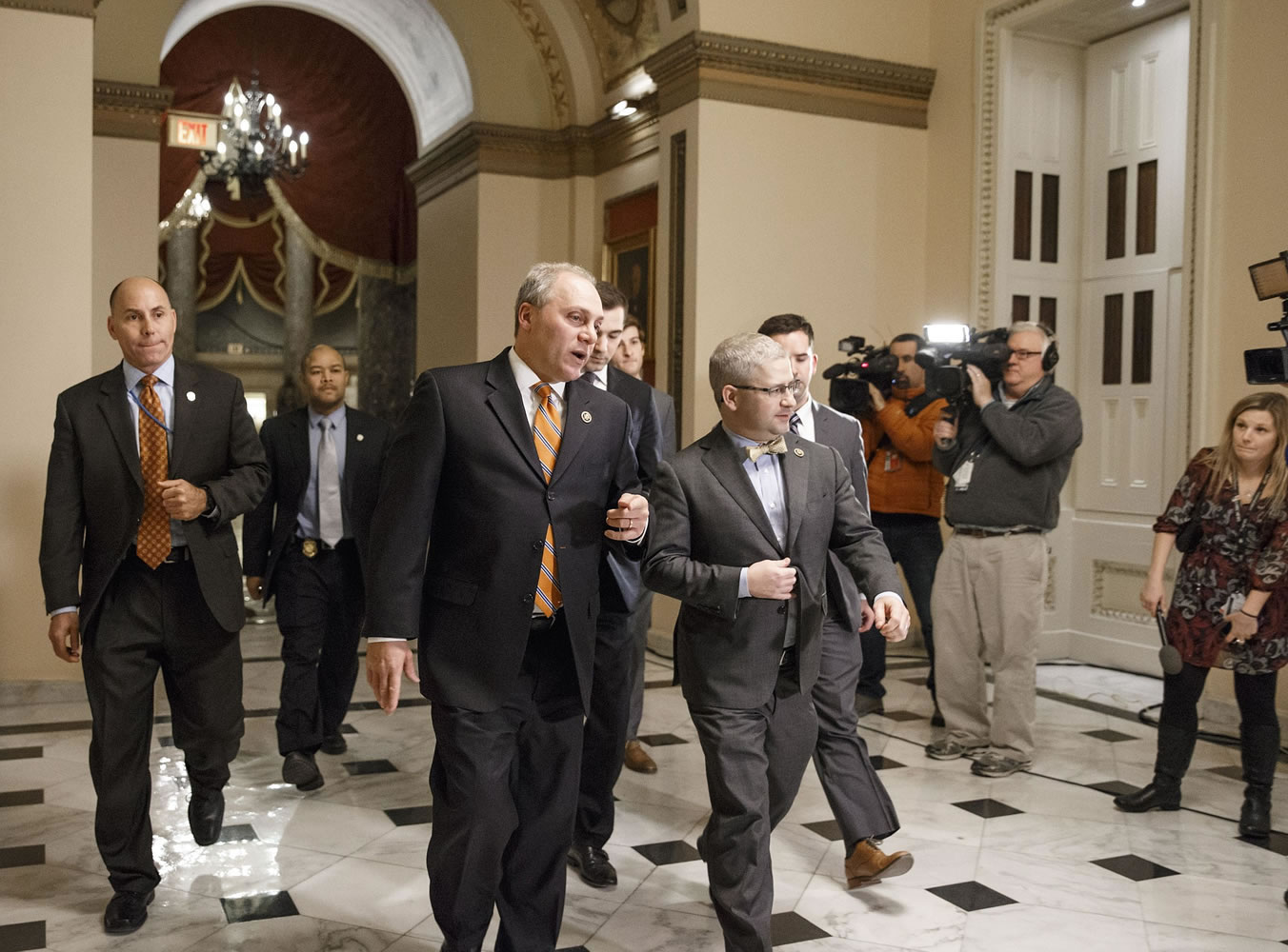 House Majority Whip Steve Scalise, R-La., center left, and  Rep. Patrick T. McHenry, R-N.C., the chief deputy whip, walk to the chamber as Congress passed a one-week bill late Friday night, Feb. 27, 2015, to avert a partial shutdown of the Homeland Security Department, as leaders in both political parties quelled a revolt by House conservatives furious that the measure left President Barack Obama's immigration policy intact, at the Capitol in Washington. (AP Photo/J.