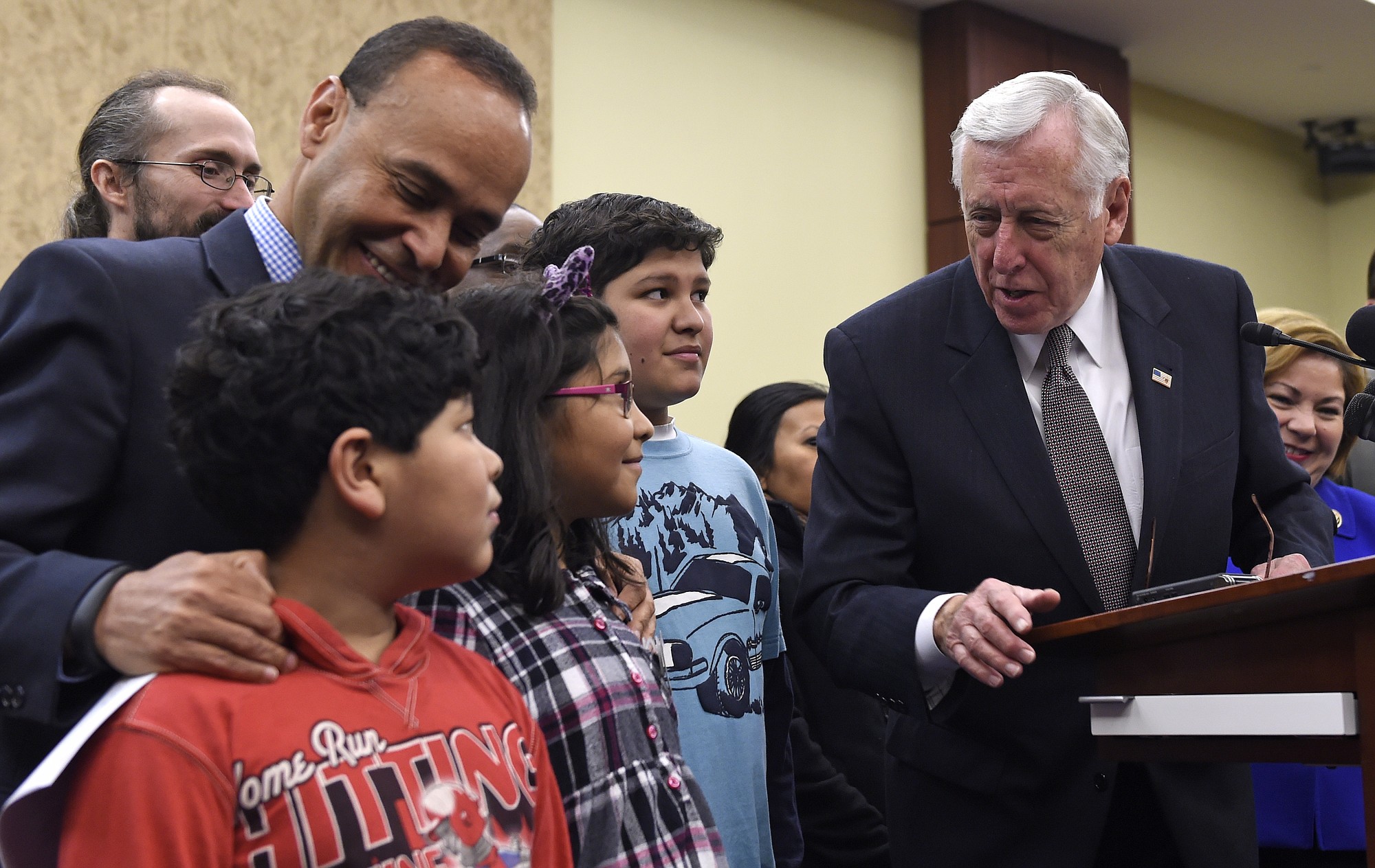 House Minority Whip Steny Hoyer of Md., right, talks to Adolofo Martinez, 13, center, Miranda Martinez, 8, and Emilio Martinez, 7, as Rep. Luis V. Gutierrez, D-Ill., listens, before the start of a news conference on Capitol Hill in Washington on Wednesday on the House Republican's immigration policies.