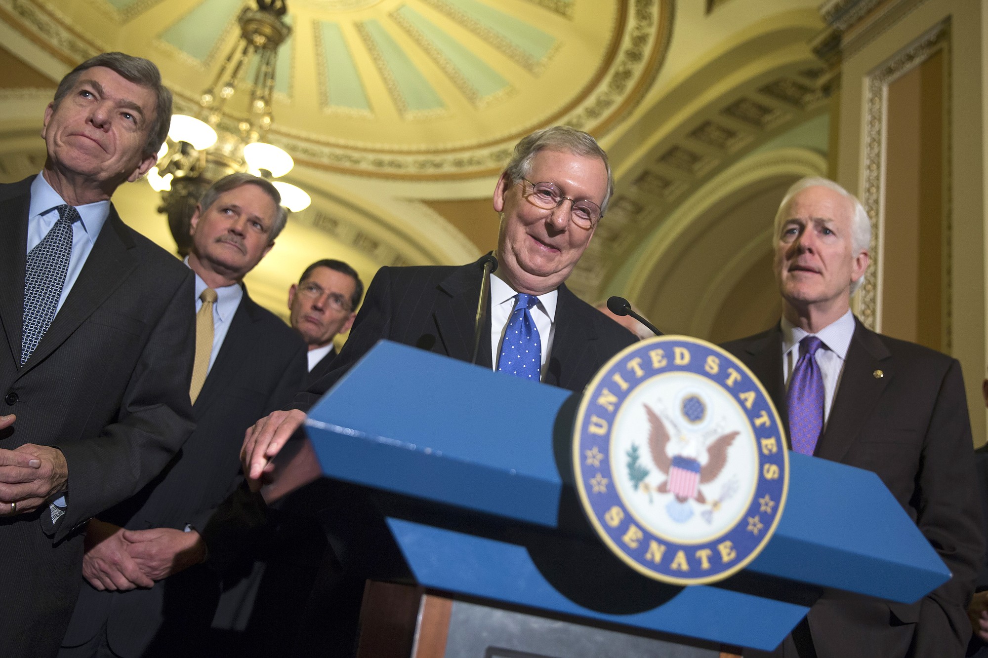 Senate Minority Leader Mitch McConnell of Kentucky smiles Thursday during a news conference on Capitol Hill in Washington after Senate Republicans voted on leadership positions for the 114th Congress. From left are, Sen. Roy Blunt, R-Mo., Sen. John Hoeven, R-N.D., Sen. John Barrasso, R-Wyo., McConnell and Senate Minority Whip John Cornyn of Texas.