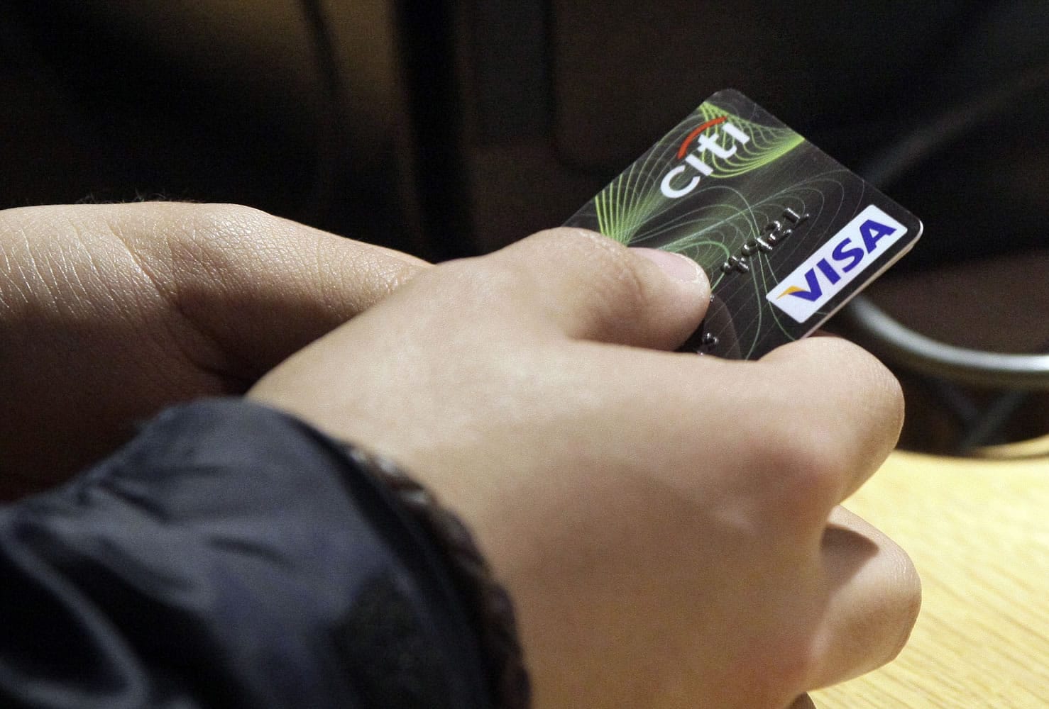A Visa credit card is offered for payment at the opening of the Superdry store in New York's Times Square.