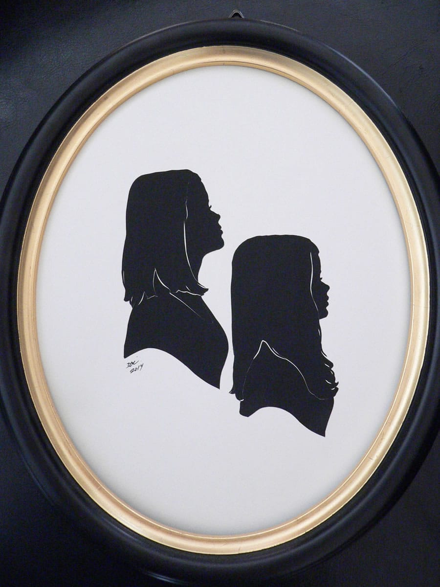 A portrait of two girls by silhouette artist Deborah O'Connor.