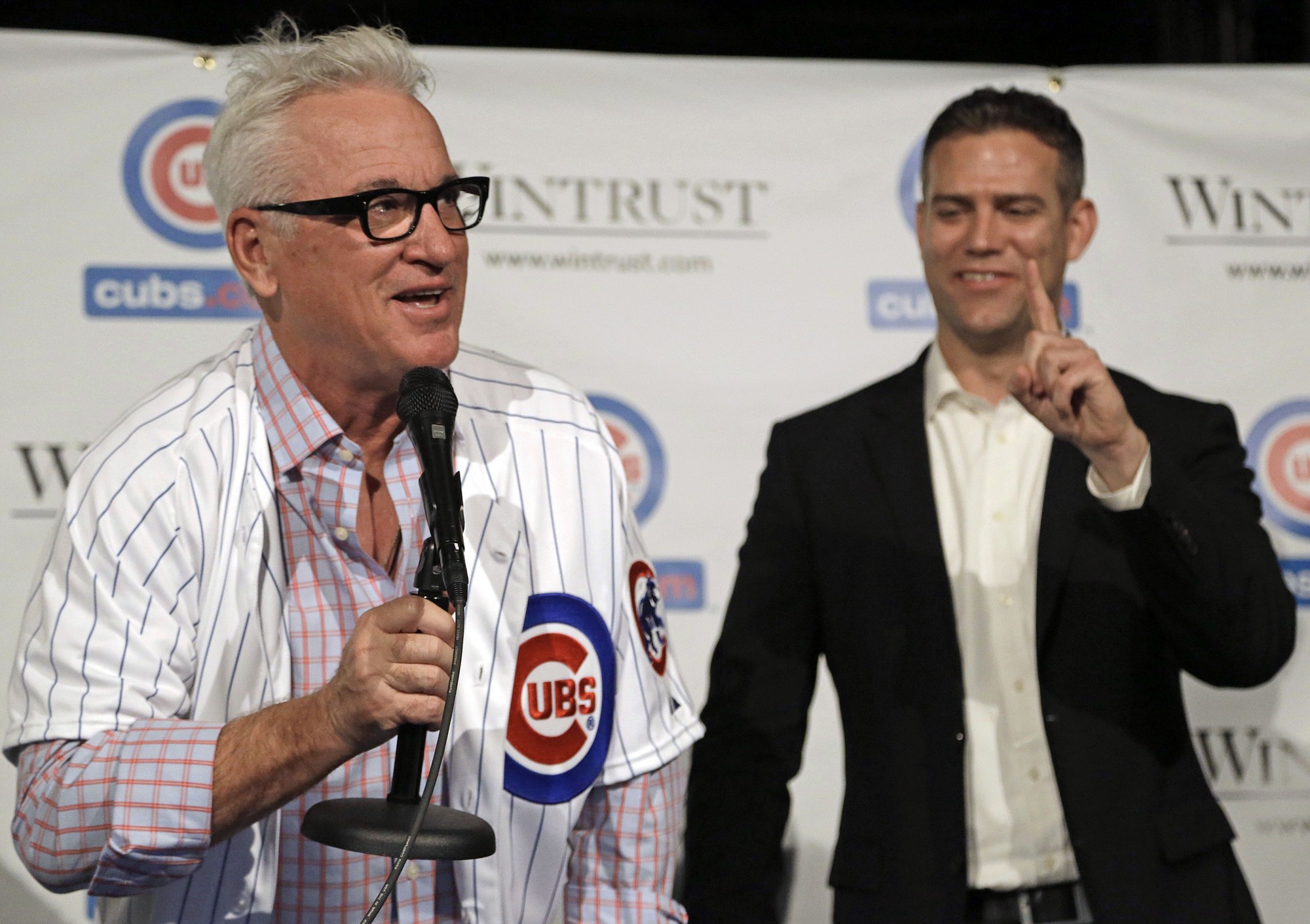 New Chicago Cubs manager Joe Maddon, left, offers to buy a round of drinks after being named manager of the Chicago Cubs baseball team at The Cubby Bear across the street from Wrigley Field, Monday, Nov. 3, 2014, in Chicago as Theo Epstein, president of baseball operations tells him only one round. (AP Photo/M.