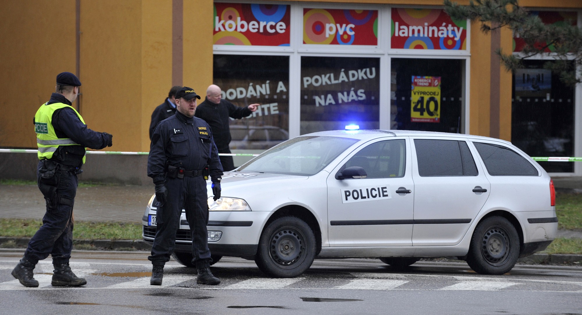 Policemen secure the area near the restaurant where a gunman opened a fatal fire before killing himself in Uhersky Brod, eastern Czech Republic, on Tuesday.