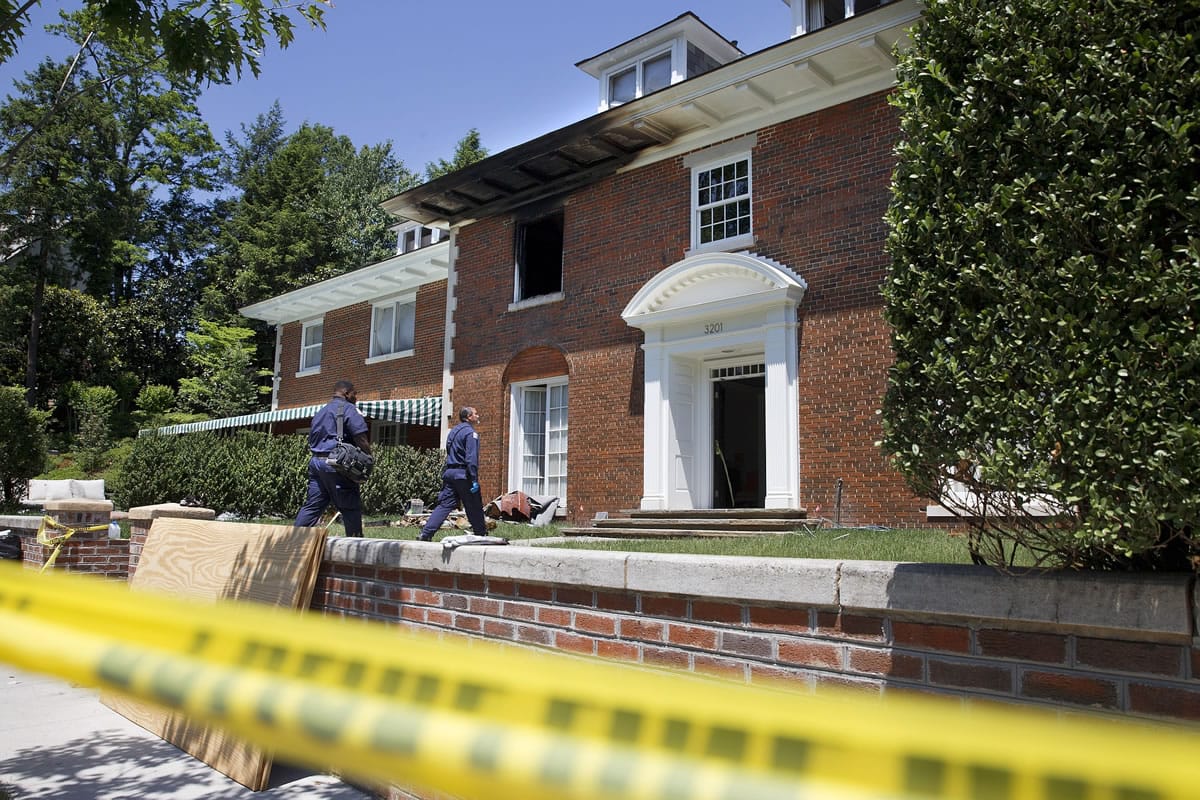 Police continue working Friday at the fire-damaged northwest Washington, D.C., home where 46-year-old Savvas Savopoulos, his wife, Amy Savopoulos, 47, the couple's 10-year-old son Philip, and housekeeper Veralicia Figueroa were found dead May 14.
