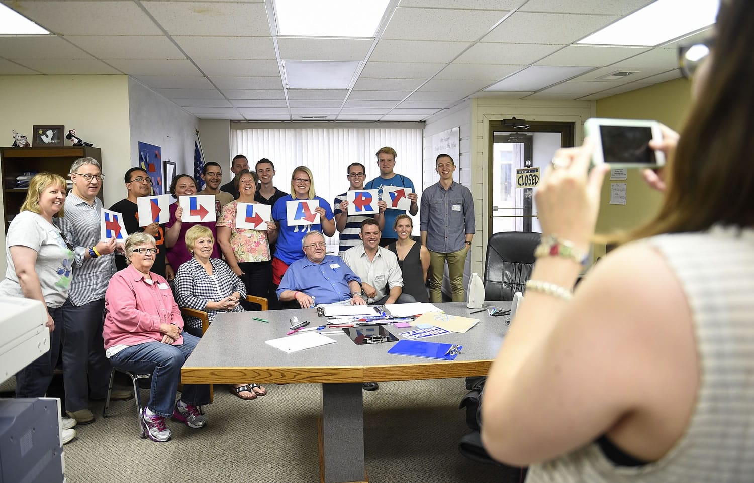 Steph Luger, 25, right, of Minneapolis, photographs the group of future volunteers at the end of the meeting at the Minnesota Democratic/Farmer/Labor Party headquarters in Mankato,  Minn., on Tuesday.