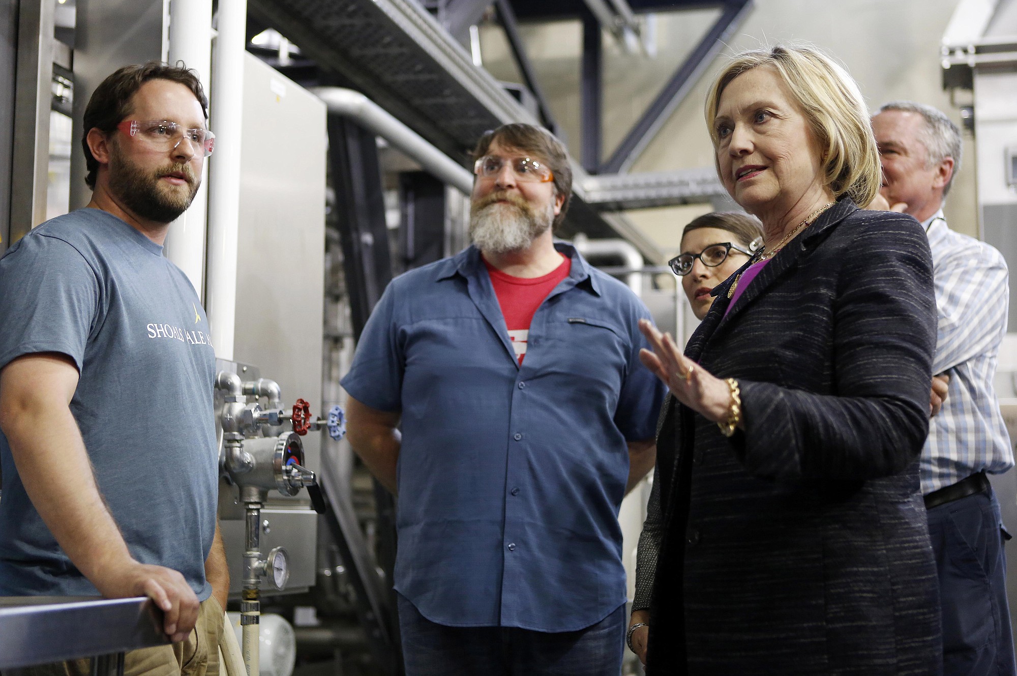 Democratic presidential candidate Hillary Rodham Clinton speaks with employees Friday during a tour of the Smuttynose Brewery in Hampton, N.H.