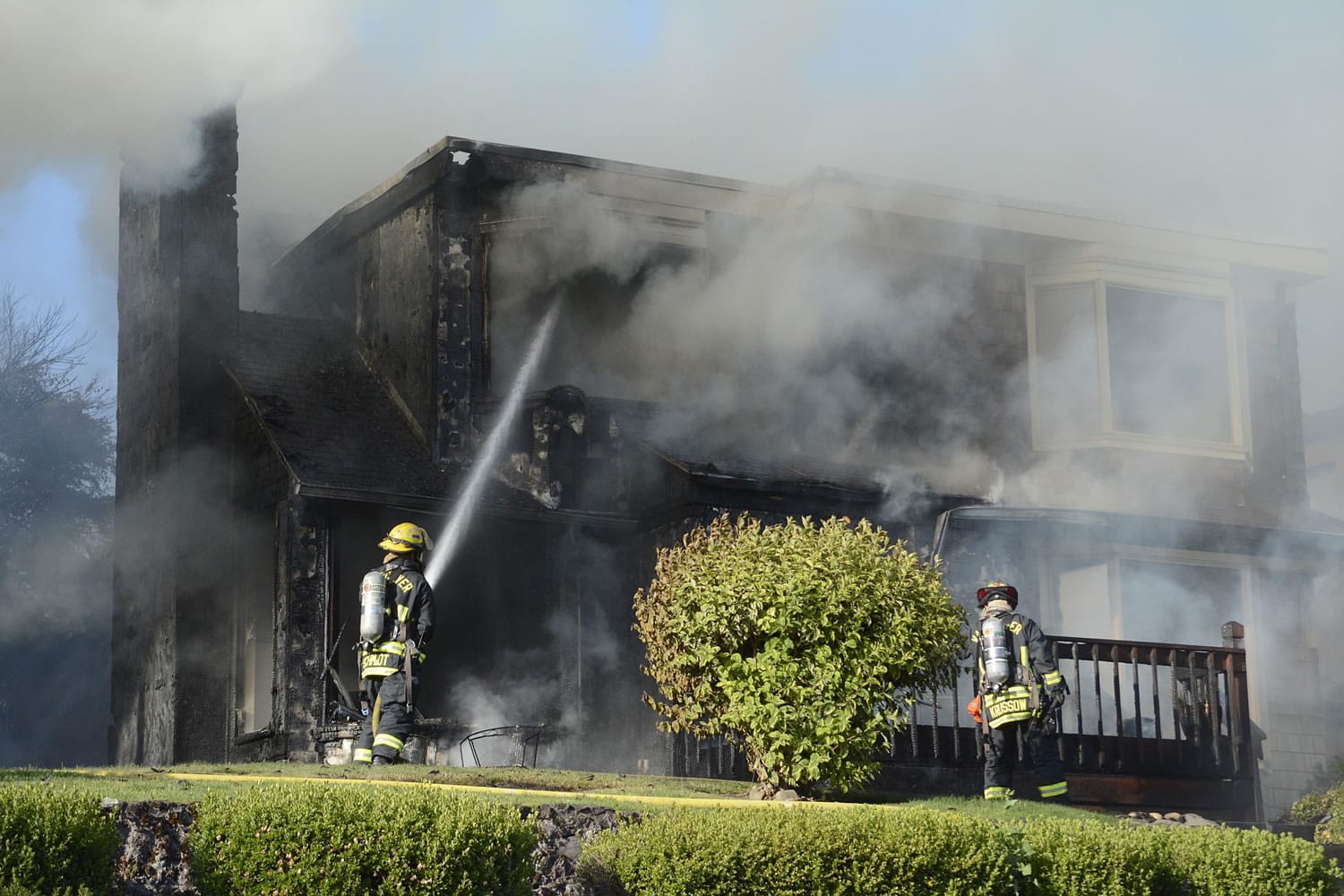 Firefighters douse two house fires in Vancouver's Old Evergreen Highway neighborhood on Wednesday evening.