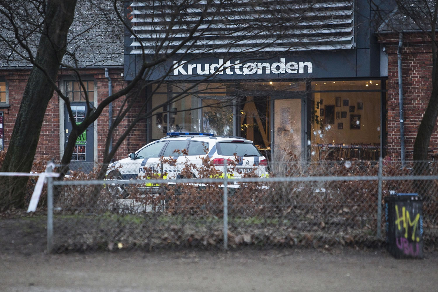 The scene outside the Copenhagen cafe, with bullet-marked window, where a gunman opened fire Saturday in what is seen as a likely terror attack against a free speech event organized by an artist who had caricatured the Prophet Muhammad.