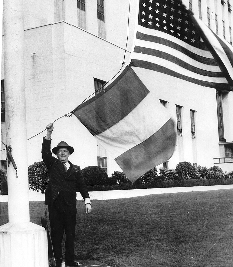 Denny Lane hoisting the Irish flag at the Clark County Courthouse on St.