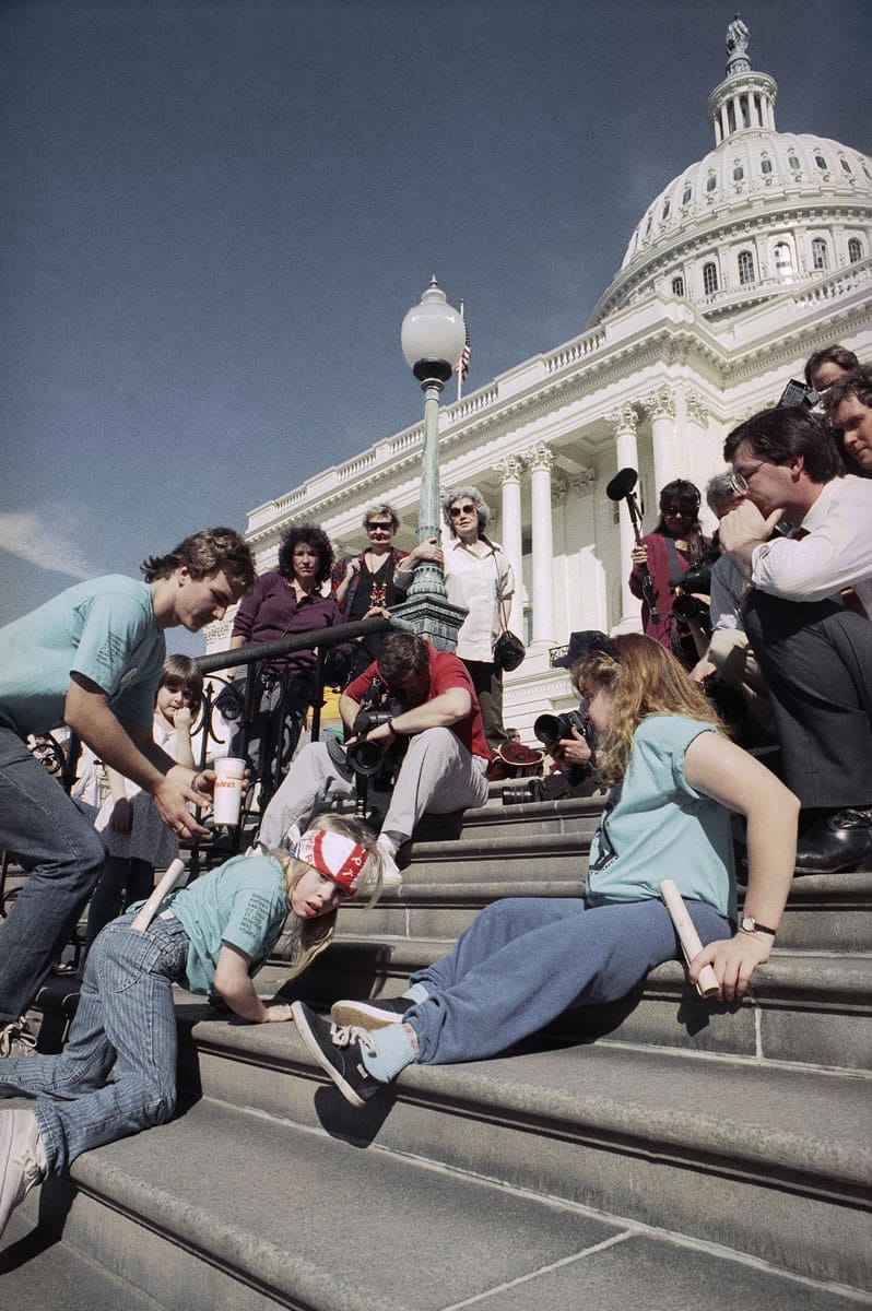 In this March 12, 1990 file photo, a group of handicapped people led by 8-year-old Jennifer Keelan, left, crawl up the steps of the U.S. Capitol in Washington, to draw support for a key bill pending in the House that would extend civil rights to disabled persons.