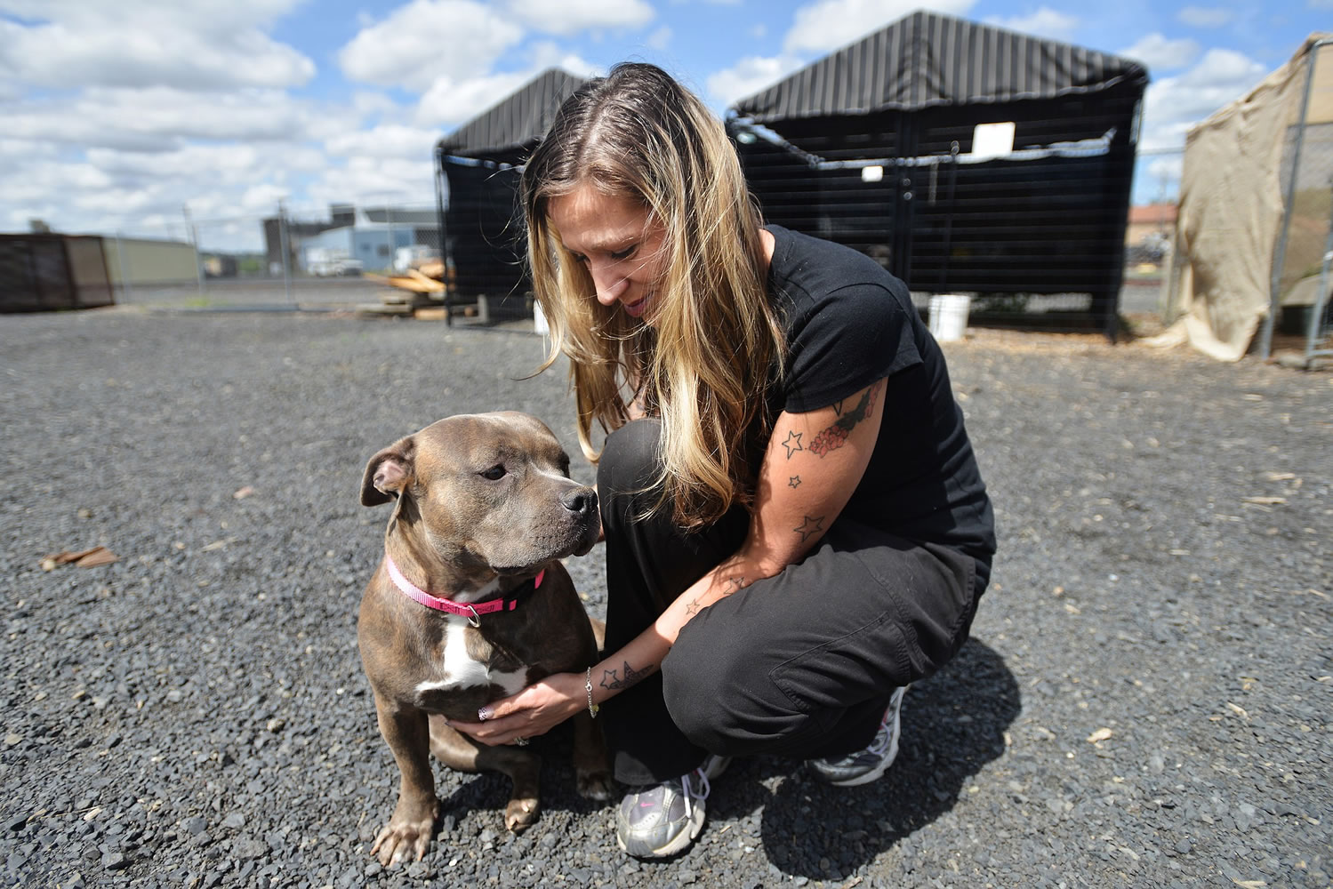 Crystal Sullenger, the manager for PAWS animal shelter in Pendleton, Ore., pets her pit bull, Star, on Thursday.