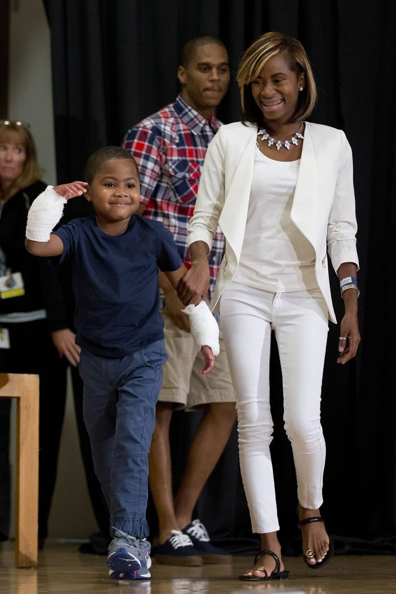Double-hand transplant recipient eight-year-old Zion Harvey arrives to a news conference with his mother Pattie Ray Tuesday, July 28, 2015, at The Children?s Hospital of Philadelphia (CHOP) in Philadelphia. Surgeons said Harvey of Baltimore who lost his limbs to a serious infection,  has become the youngest patient to receive a double-hand transplant.