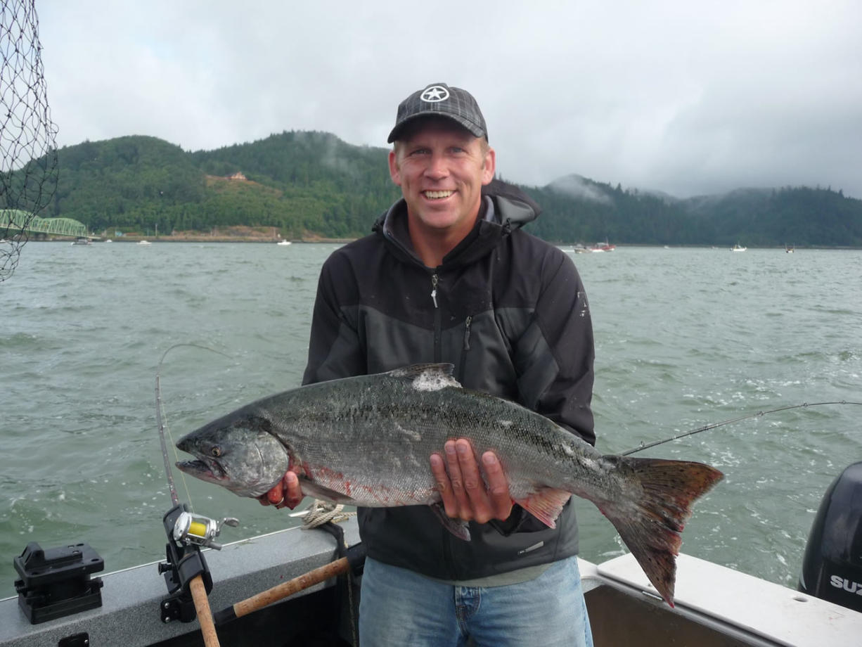 Doug Borneman of Bellingham, Wash., holds a small chinook caught near the Astoria Bridge.