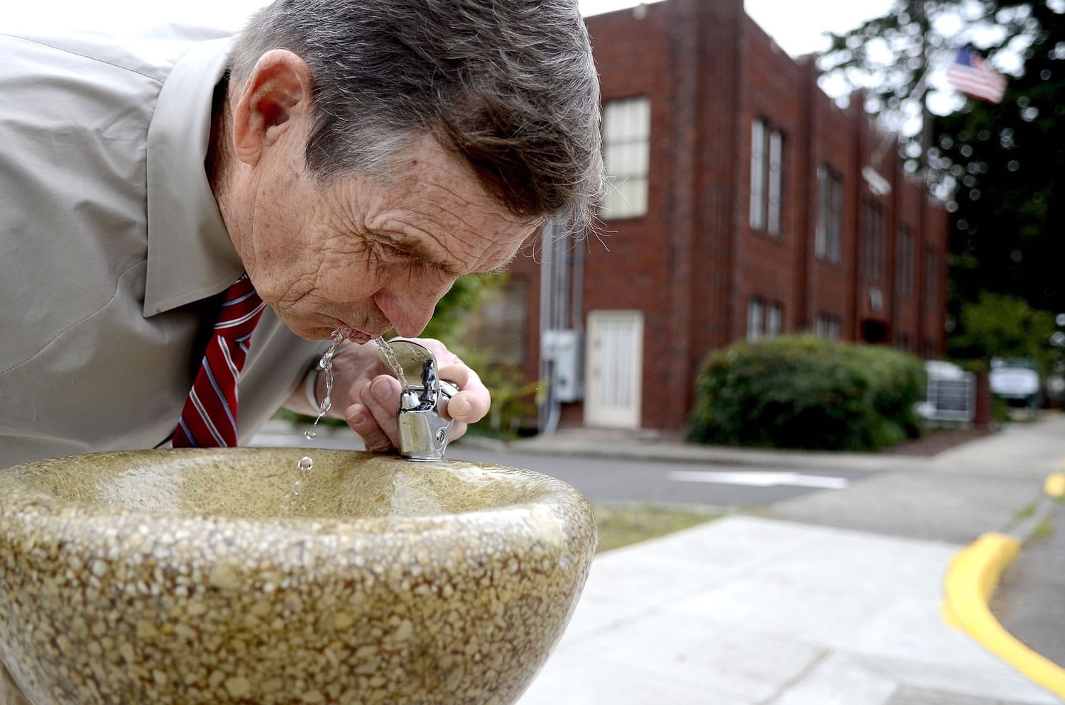 Anna Reed/Statesman-Journal
Marvin Sannes takes a sip Monday from the public drinking fountain he worked for more than two years to install near the Old West Salem City Hall in West Salem, Ore.
